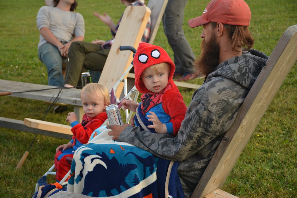 Dad and Children Sitting at Campfire in PJs